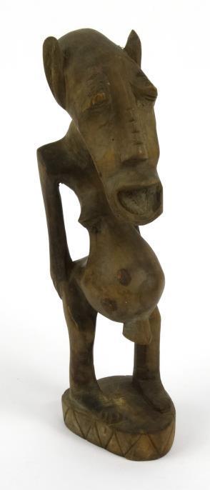 Carved wooden tribal figure of a pot-bellied long-faced gentleman, 30cm high : For Condition