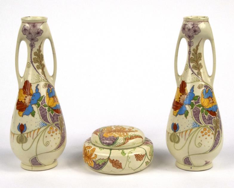 Pair of Gouda Art Nouveau vases and a similar box and cover, each decorated with stylised flowers