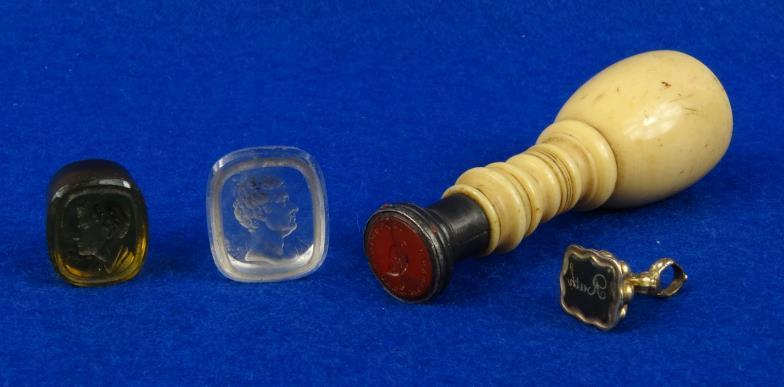 19th Century ivory handled seal with engraved matrix, together with two glass intaglios and a