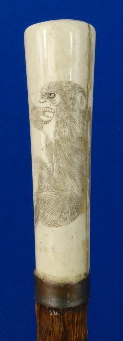 Oriental wooden walking cane, the bone handle carved with a monkey : For Condition Reports Please