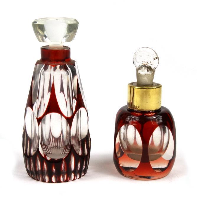 Two cut glass scent bottles with red flashed decoration - one stamped `Mikado` to the collar, the