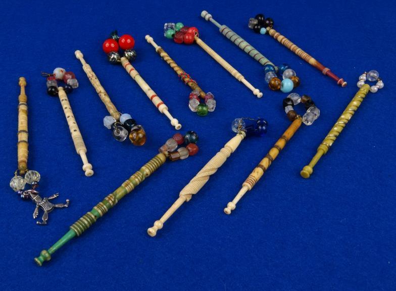 Collection of antique bone and composition bobbins with coloured glass and beadwork decoration :