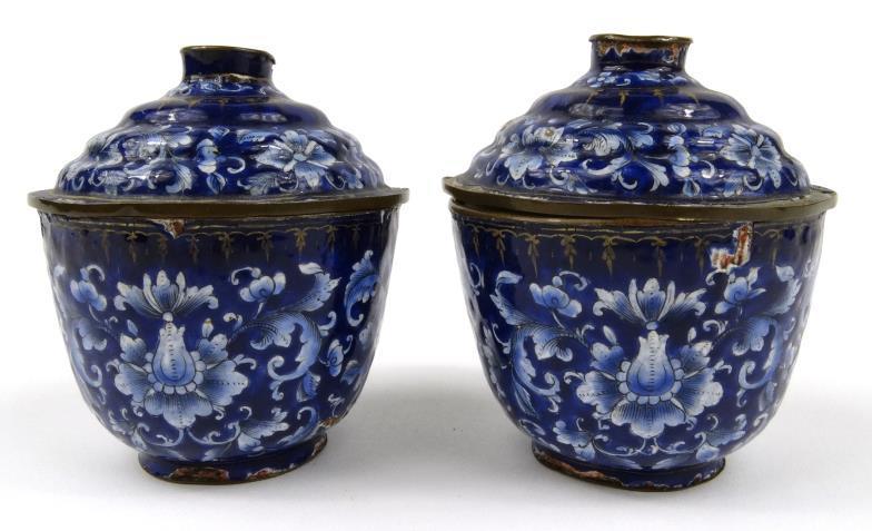 Pair of oriental enamel bowls and covers, each painted with flowers onto a blue and gilt ground,