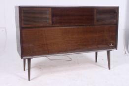 A vintage 1950`s German Grundig laquered music cabinet / radiogram with enclosed record player and