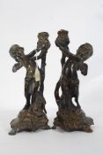A good quality pair of bronze early 20th century table lamps in the form of cherubs