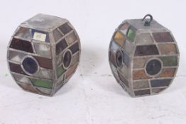A pair of 1920`s Arts & Crafts revival oak lined stained glass lanterns. Of square bulbous form