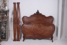 A 19th Century French carved solid walnut double bed. Of  ` cartouche  form, the head and foot