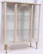 A retro 1950`s glass display cabinet with swing door and shelves to interior raised on tapered