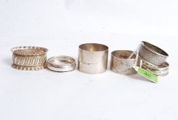 A collection of 6 assorted silver hallmarked napkin rings to include Birmingham EW, Chester S.B.L,