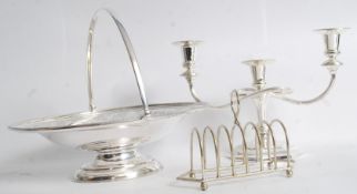 A silver plate candelabra fruit bowl and toast rack
