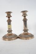 A Pair of silver plate on copper candle sticks on circular bases raised in relief Sheffield candle