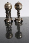 A pair of Russian silver cruets. Both modelled with scholar mounts two figures on the salt, three to