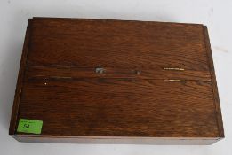 A good 20th century oak cutlery box with twin hinged lid having a quantity of assorted flatwares,