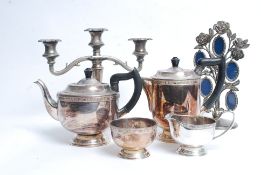 A large collection of silver plated wares to include salvers, cigarette case, vases, candelabra,