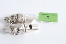 A pair of white metal (stamped 925 silver ) whistles, with the ends being the form of dogs heads,