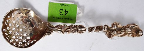 A fine quality Victorian solid silver hallmarked tea strainer of rococo form, possibly by Samuel