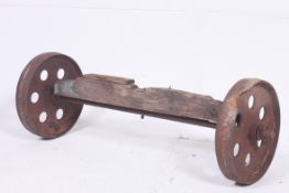 A Victorian cast iron pair of dram / railway wheels united by the original wooden axle
