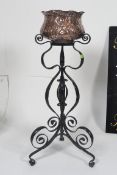 A decorative Arts and Crafts Wrought Iron jardiniere along with a Cornish Arts and Crafts copper