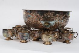 A large art nouveau style silver plate punch bowl and matching cups. Stamped to base 'made in