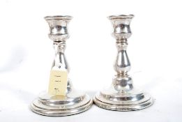 A pair of silver hallmarked candlestick by M C Hersey & Son Ltd bearing london hallmarks for 1995.