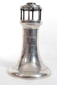 A silver ( tested) table top ornament in the form of a lighthouse. Measures 17cms high. 438g gross