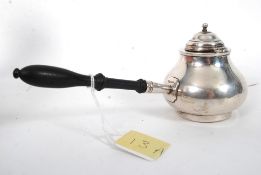 A silver 19th century inkwell in the form of a brandy warmer having hinged lid with tapered and