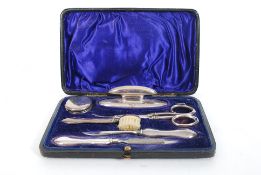 A mid 20th century solid hallmarked silver manicure / travel set, comprising of brushes, scissors