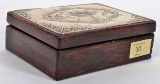 A hallmarked silver topped cigar / trinket box with pressed silver embossing to top and clear