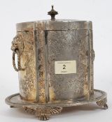 An 19th / 20th century silver plate biscuit barrel Tea Caddy chased in relief with lion head mask