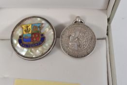 Two white metal ( stamped ' silver ' ) items to include a Saltcoats badge and a Poetry Society fob