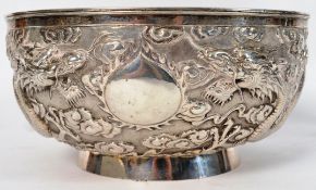A 19th century Chinese silver bowl of circular form raised on relief with 4 claw dragon in the