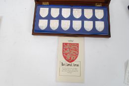 A 1970`s cased set of twelve shield shaped silver ingots "The Royal Arms" in commemoration of QEII