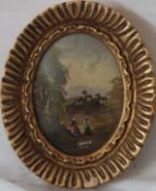 An Italian miniature oil painting of a castle and village scene set within a gilt oval frame.