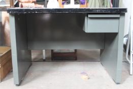 A vintage mid 20th century Industrial metal painted grey office desk having open kneehole with