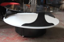 A retro 1970`s melamine and smoked glass circular coffee table. The white melamine base with inset