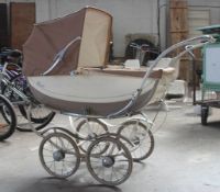 A vintage 1950`s enamel painted Royale pram by Gerald S White having canvas cover. Measures 115 cms