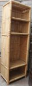 A tall contemporary open window bamboo bookcase cabinet. The rattan weave body being upright having