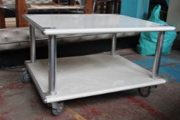 A vintage late 20th century Habitat plastic and tubular metal twin tier trolley being raised on