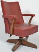 A vintage mid 20th century industrial beech wood and red vinyl office desk  swivel chair.  Raised