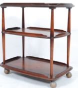 A retro 1970`s Ercol 3 tier beech and elm butlers tea trolley having oversized castors with 3