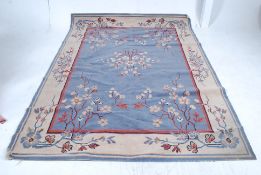 A 20th century machine woven Persian style rug with blue background having central medallion design