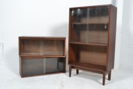 A mid century freestanding shelf unit with sliding glass doors to the upper portion along with two