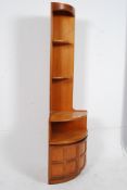 A 1970`s retro Nathan corner cabinet in teak having cupboard to base  with upright shelving to the
