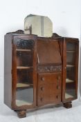 A 1930`s Art Deco oak drop centre bureau bookcase having twin glass bookcase cabinets, bureau to