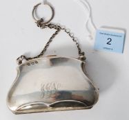 A hallmarked Edwardian silver purse with chain in clam form being leather sectional lined.