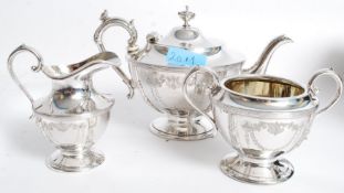 An Edwardian silver plate tea set, pot, creamer and sugar bowl T W & Co Ltd