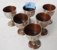 A set of 6 Chinese silver plate egg cups raised in relief with dragons. The silver plate on copper.