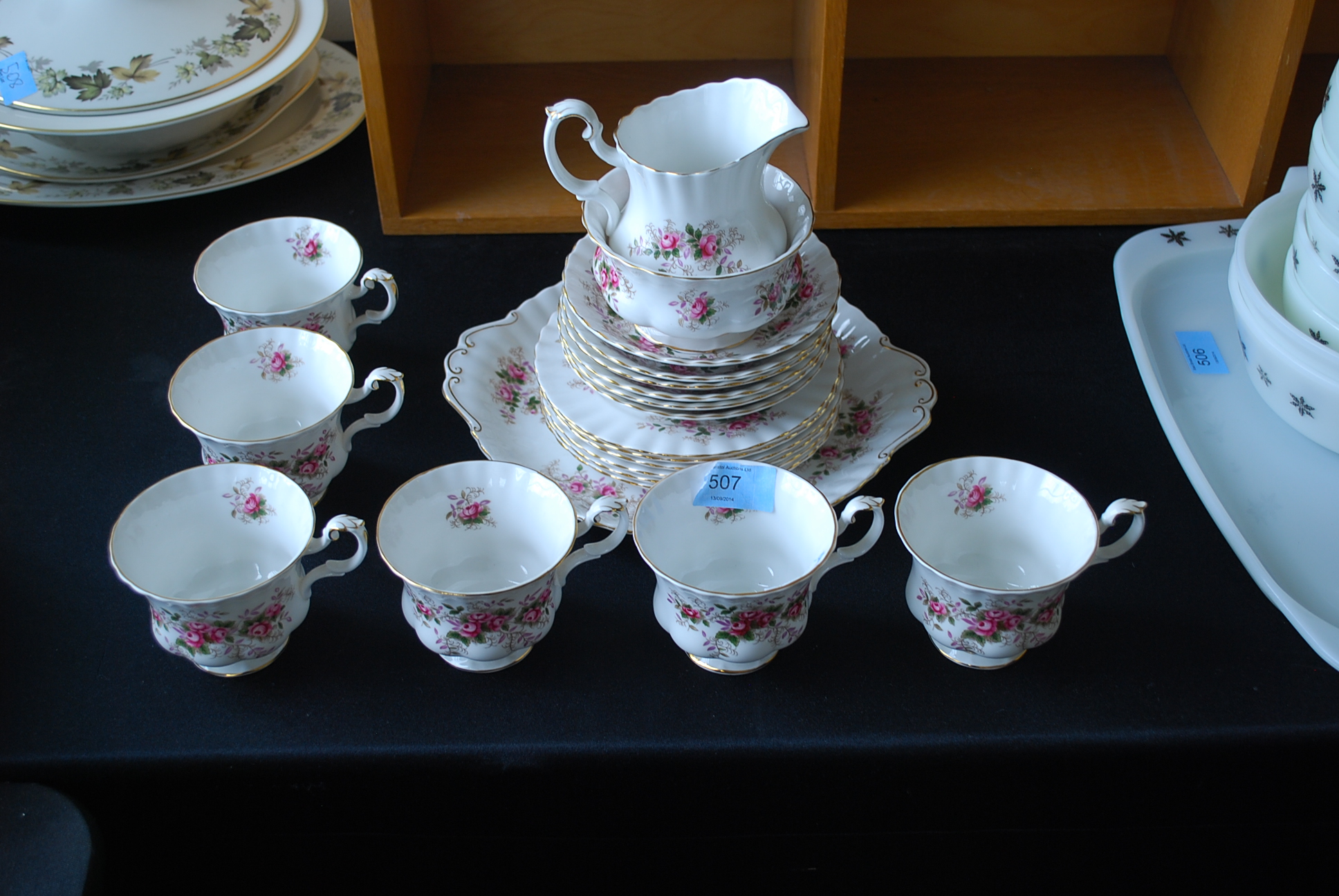 A Royal Albert part tea service in a floral pattern comprising cups, saucers, cake plate, sugar bowl