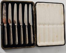 A set of six cased silver hallmarked fruit knives stamped J.S