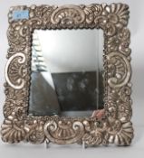 A large early 20th century silver 925 picture frame having oversized rococo embossed silver frame